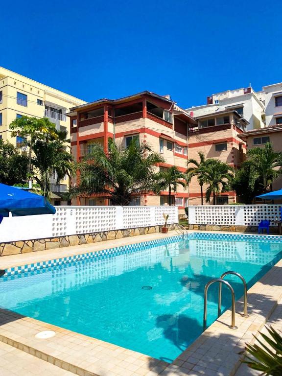 a large swimming pool in front of a building at jennies staycation in Mombasa