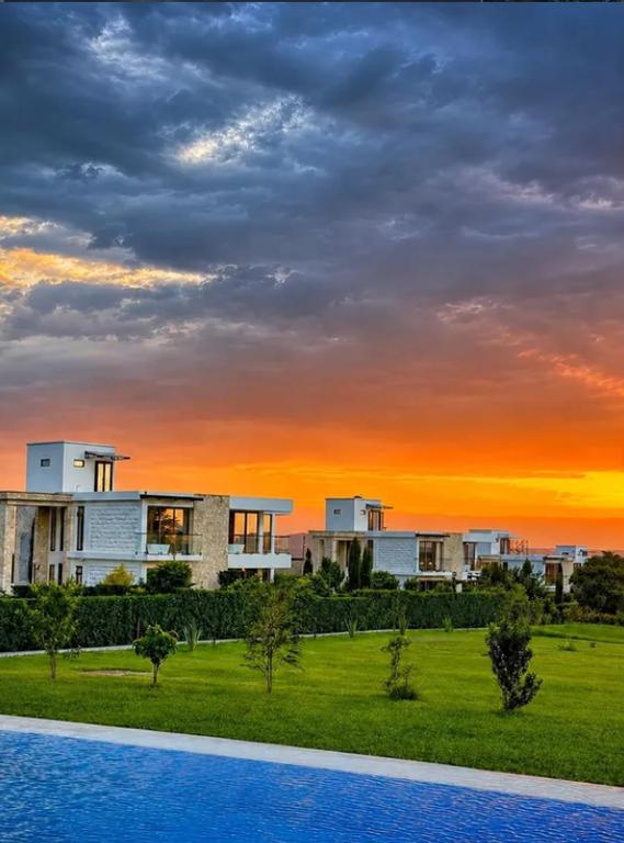 a view of a building with a sunset in the background at Flamingo Bay in Nakuru
