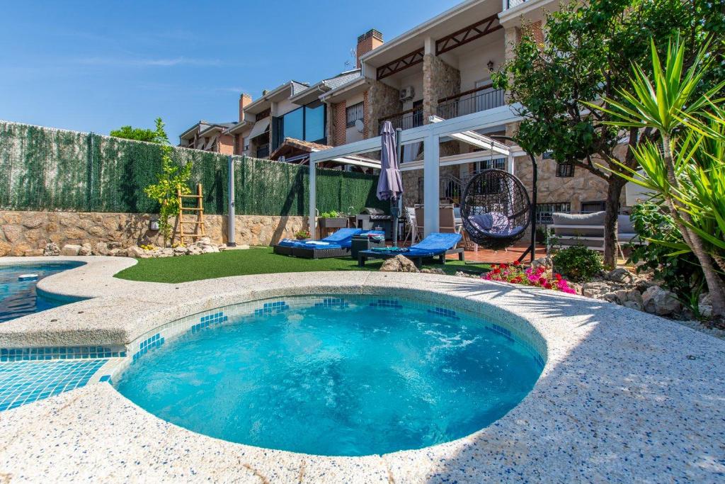 a swimming pool in the backyard of a house at Charming Studio with Pool Retreat in Arroyomolinos
