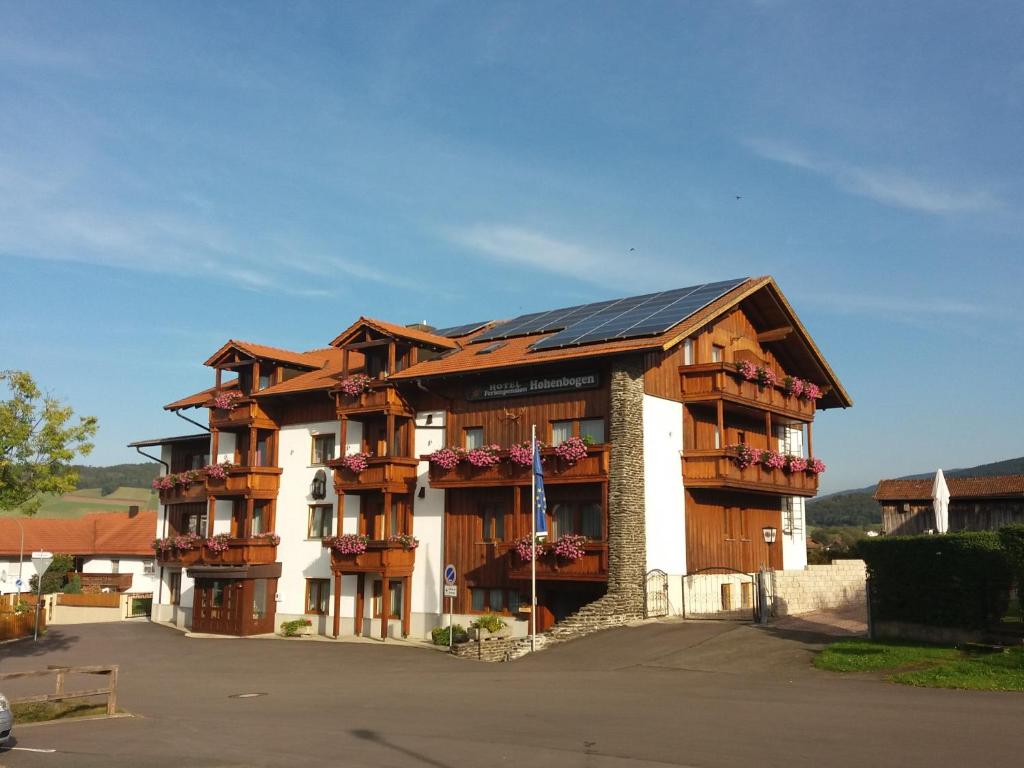 an apartment building with balconies and a roof at Genusshotel Hohenbogen GARNI in Neukirchen beim Heiligen Blut