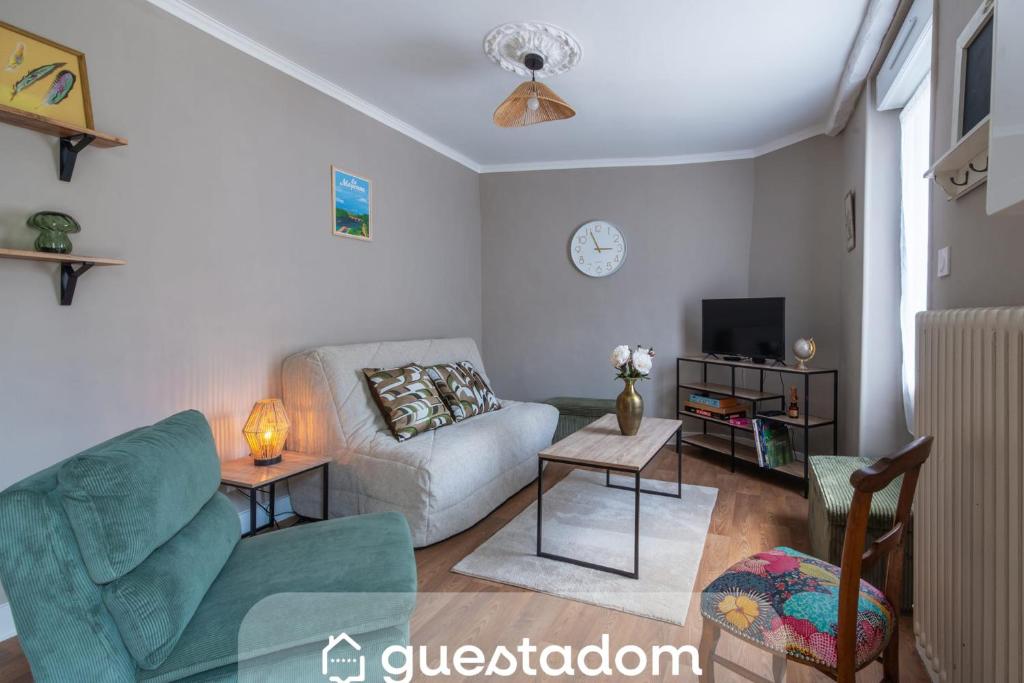 a living room with a couch and a tv at Brise Lavalloise - Wifi - Centre Ville in Laval