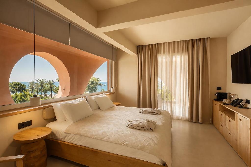 a bedroom with a large bed with a window at La Gaia - Adult Only in Alanya