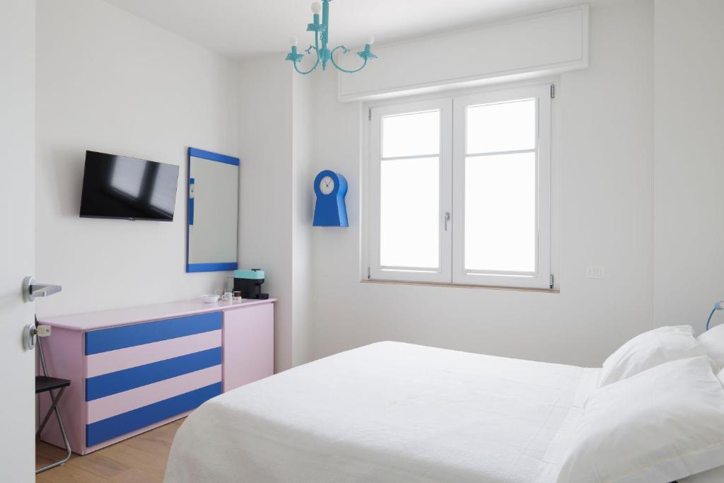 a bedroom with a bed and a dresser and a window at VItruVIo POP in Fano