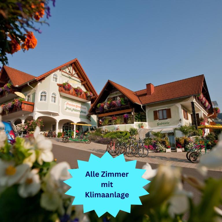 a couple of buildings with flowers in front of them at Pension Gabriele in Unterlamm