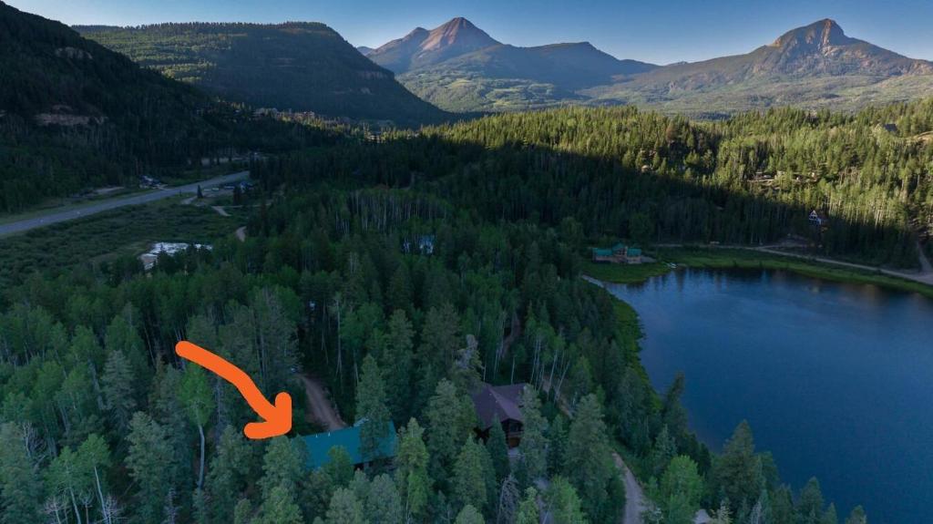 an aerial view of a lake with trees and mountains at 246 Beaver Circle in Durango Mountain Resort