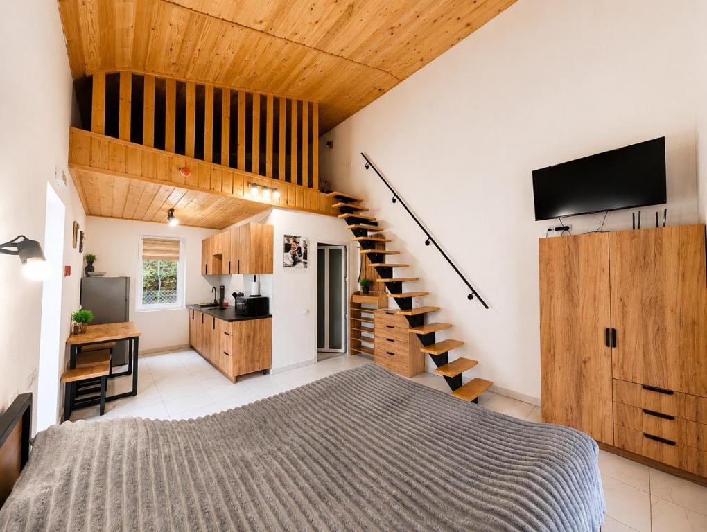 a bedroom with a bed and a staircase at Апарт Стефанія in Skhidnitsa