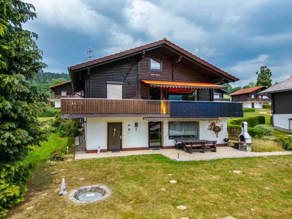 a house with a large yard with a patio at Ferienwohnung Spatzennest in Arrach