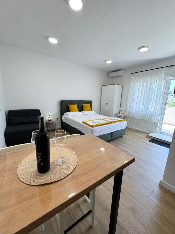 a bottle of wine on a table in a living room at Studio Sanja in Vlašići