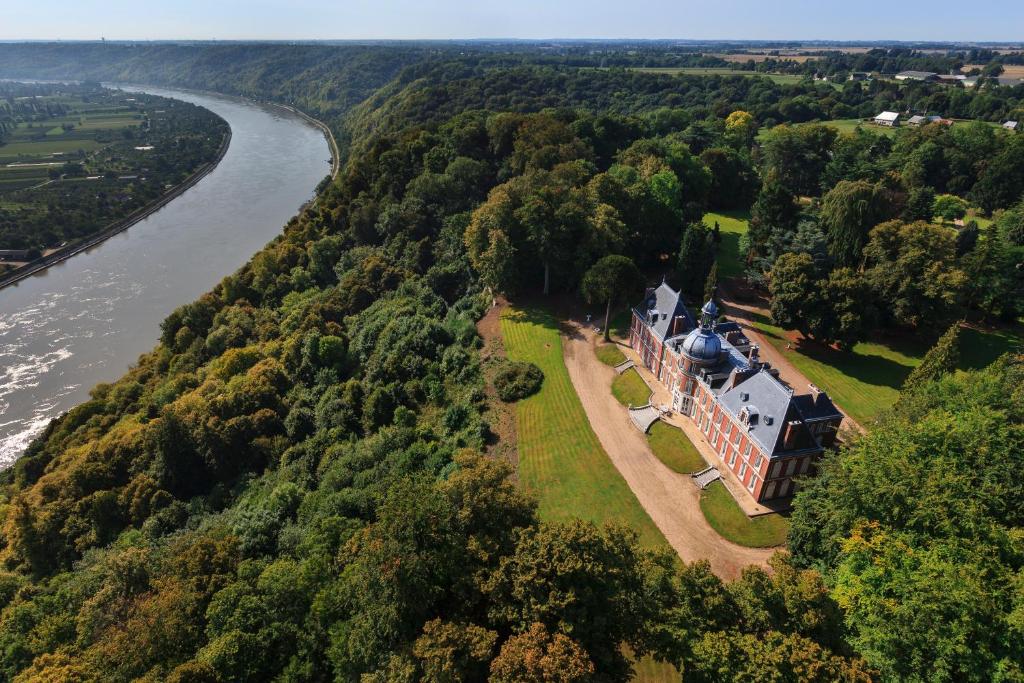 an aerial view of a mansion next to a river at Chateau Du Landin in Le Landin