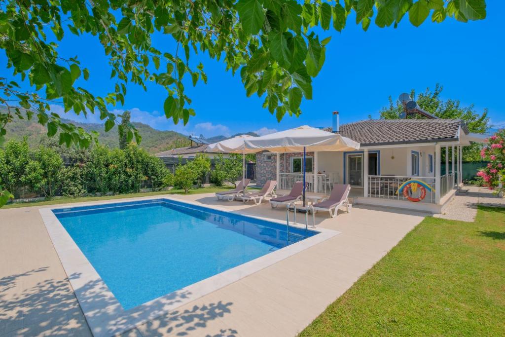 a swimming pool in the backyard of a house at Villa Ata Park Ortaca in Ortaca