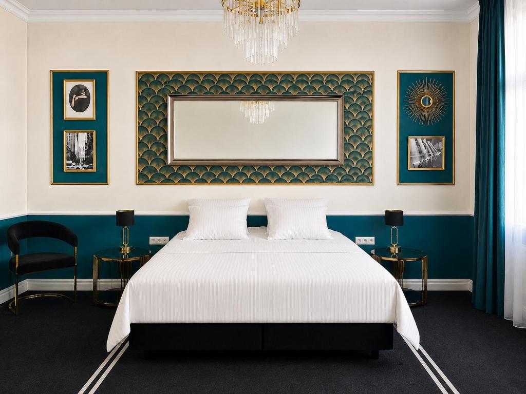 a bedroom with a bed and a chandelier at Willa Ingeborg in Międzyzdroje