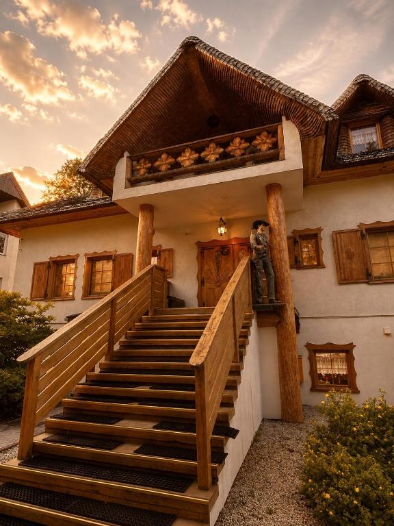 a house with a staircase leading to the front door at Dworek w Karpaczu in Karpacz