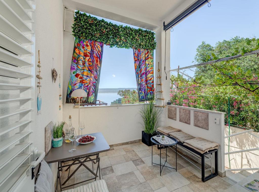a room with a window and a table at Apartment Matoš in Omiš