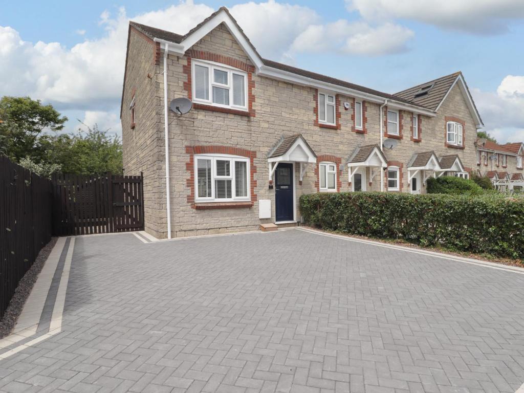 a brick house with a driveway in front of it at 7 Cwrt Y Cadno in Llantwit Major