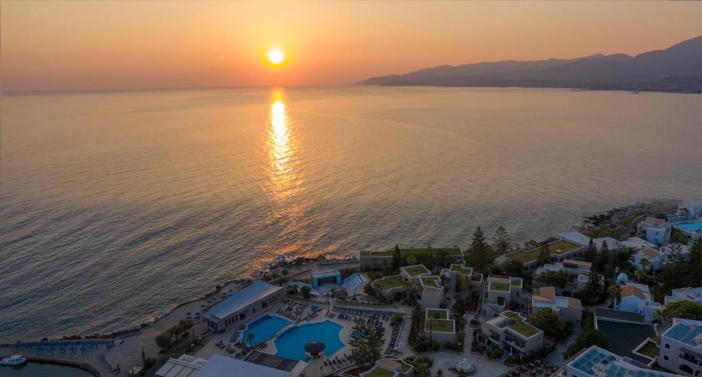 an aerial view of a city and the ocean at sunset at Nana Golden Beach All Inclusive Resort & Spa in Hersonissos