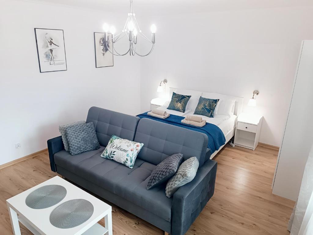 a living room with a couch and a bed at Royal Nest Apartment Sandomierz in Sandomierz