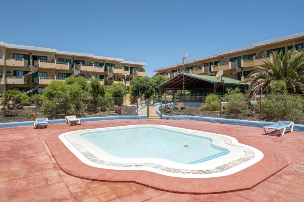 a large swimming pool in front of a building at Rayito de sol 3 in Costa de Antigua