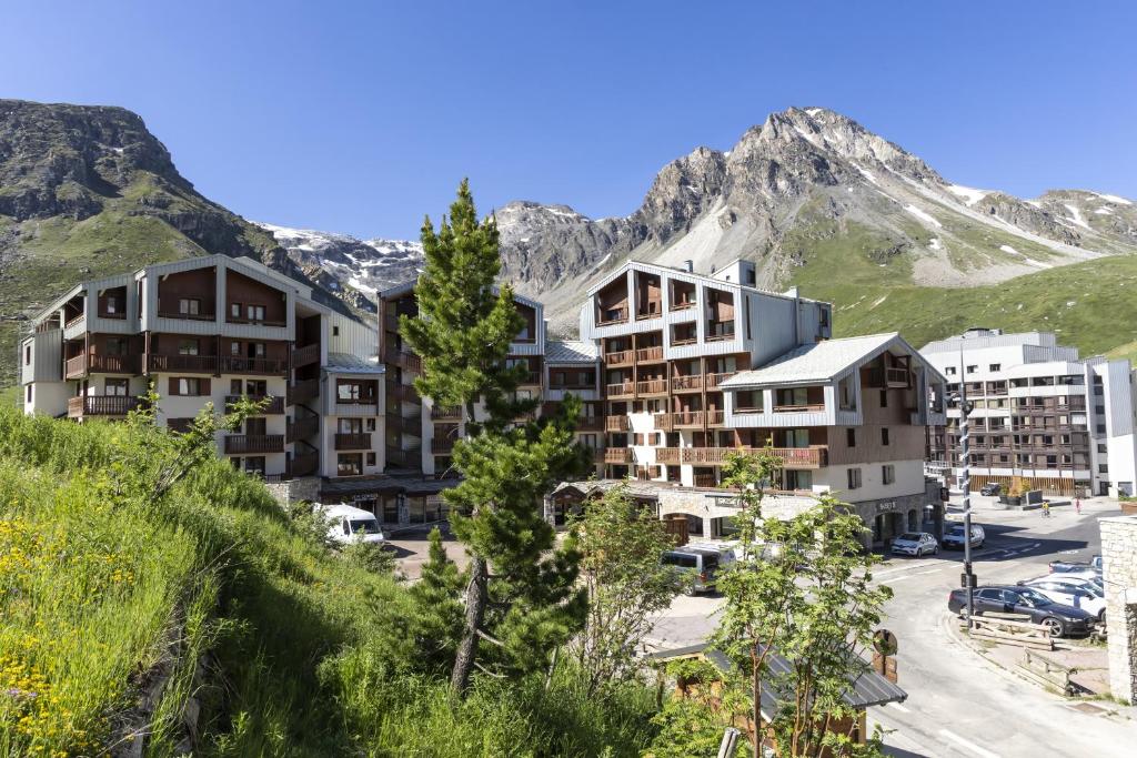 a group of buildings in front of a mountain at Résidence Odalys Le Hameau du Borsat in Tignes