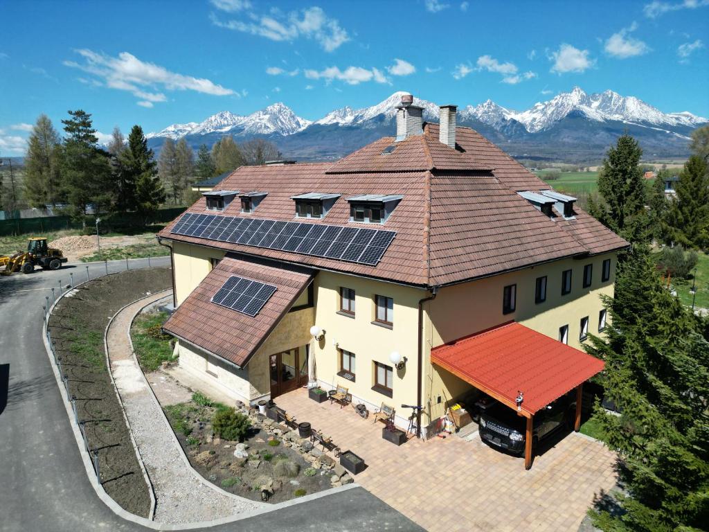 a house with solar panels on top of it at Mlyn Tatry Resort in Veľký Slavkov