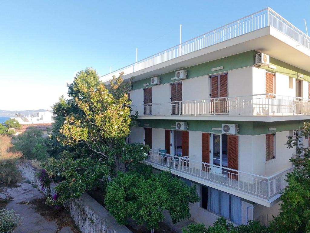 a building with balconies on the side of it at Puente Rooms in Methana