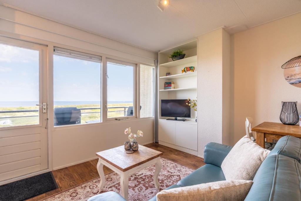 a living room with a couch and a table at Appartementencomplex Juliana 108 in De Koog