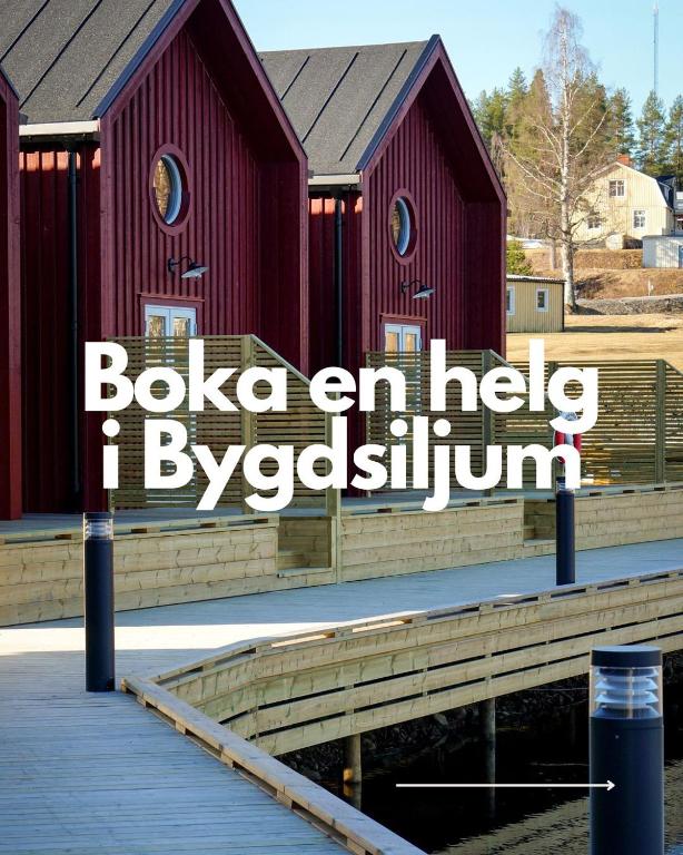 a red building with the words bulka an he help by jeyevlyn at Bygdsiljums Sjöbodar in Bygdsiljum