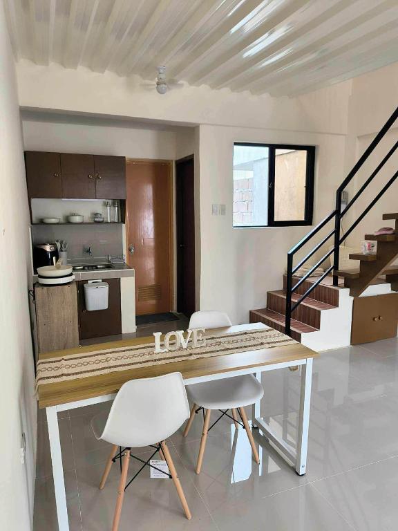 a kitchen and dining room with a table and chairs at Sta Cruz Laguna Transient House in Santa Cruz