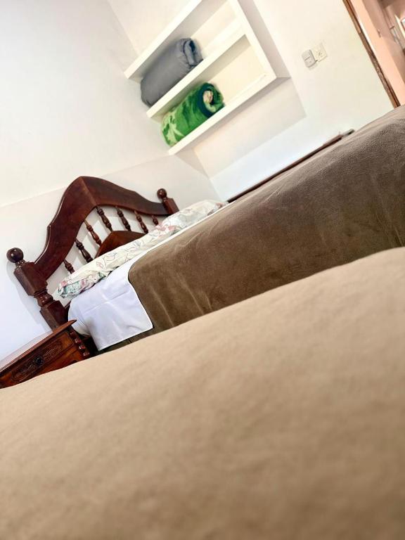 a bedroom with a bed and a mirror on the wall at Casa dos dormitorios in Bella Vista