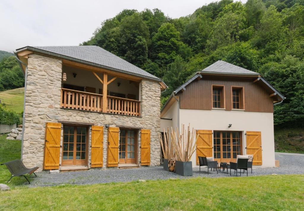 a house with a deck on the side of it at Les Chalets de l'Ours in Cauterets