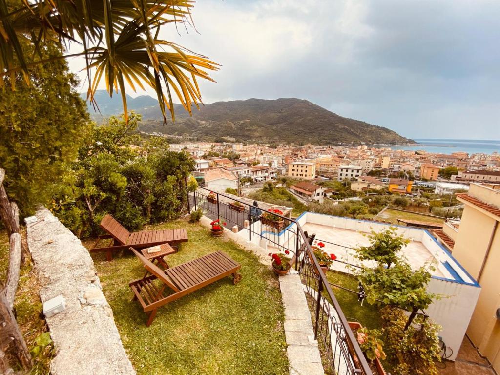 a balcony with benches and a view of a city at Bed & Breakfast Spigolatrice in Sapri