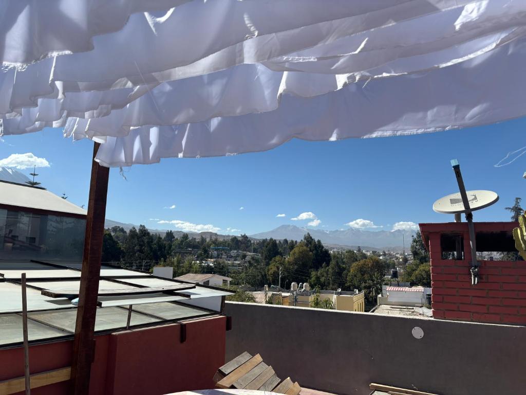 a white umbrella on top of a roof with mountains at Casa Junto al Rio in Arequipa