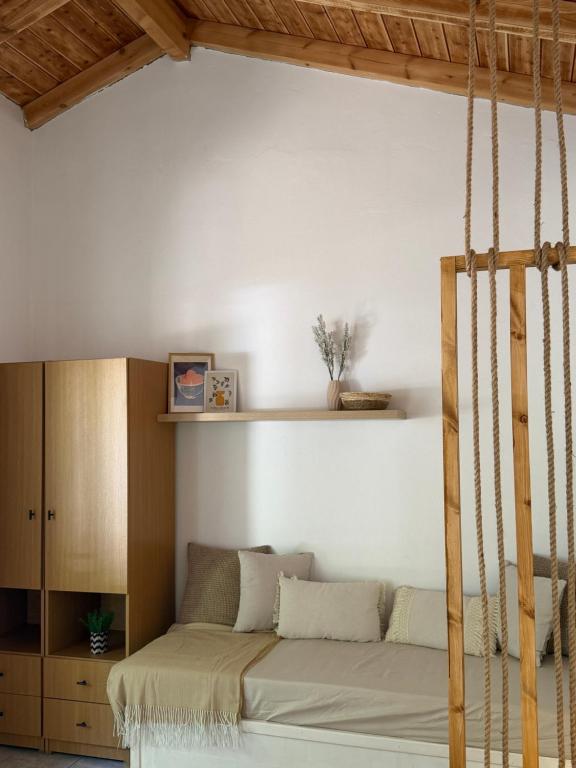 a room with a bed with a swing at The Beach House in Vasilika
