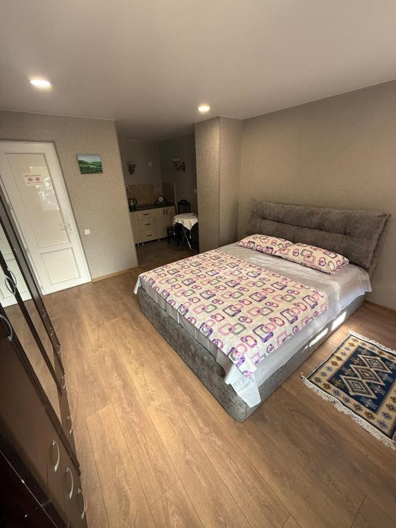 a bedroom with a large bed in a room at Heart of Mtskheta Studio Apartment in Mtskheta