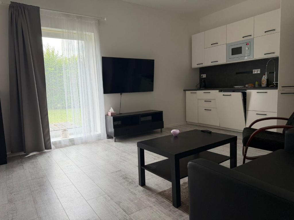 a living room with a couch and a table at Apartman VIKY in Bartovice