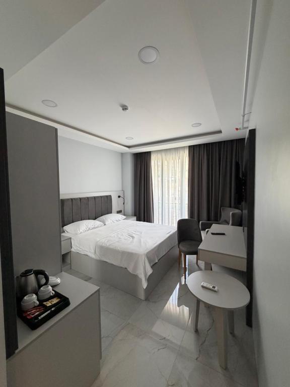 a hotel room with a bed and a desk at Sesse suit in Istanbul