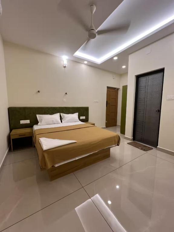 a bedroom with a bed and a ceiling fan at Ayra Inn in Cochin