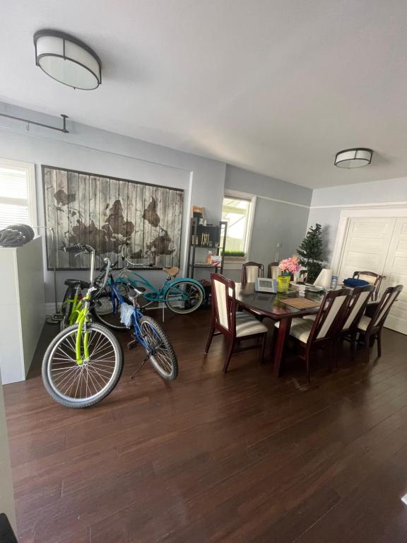 a bike parked in a living room with a table and chairs at Vancouver east downtown queen bed room share bathroom in Vancouver
