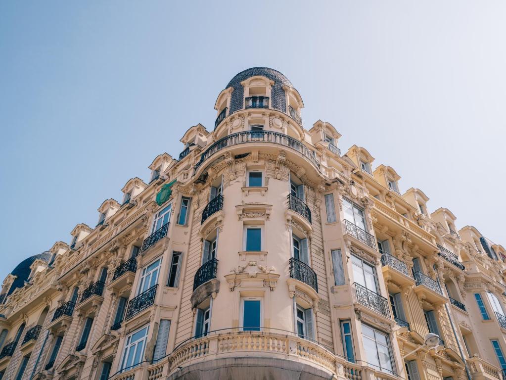 a tall building with balconies on top of it at Hotel La Villa Nice Victor Hugo in Nice