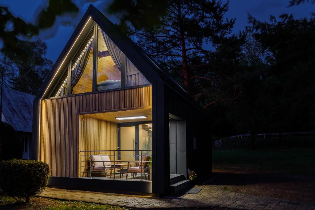 a house with a large window on the side of it at Chalet - AQUA MARIA RESORT in Veľaty