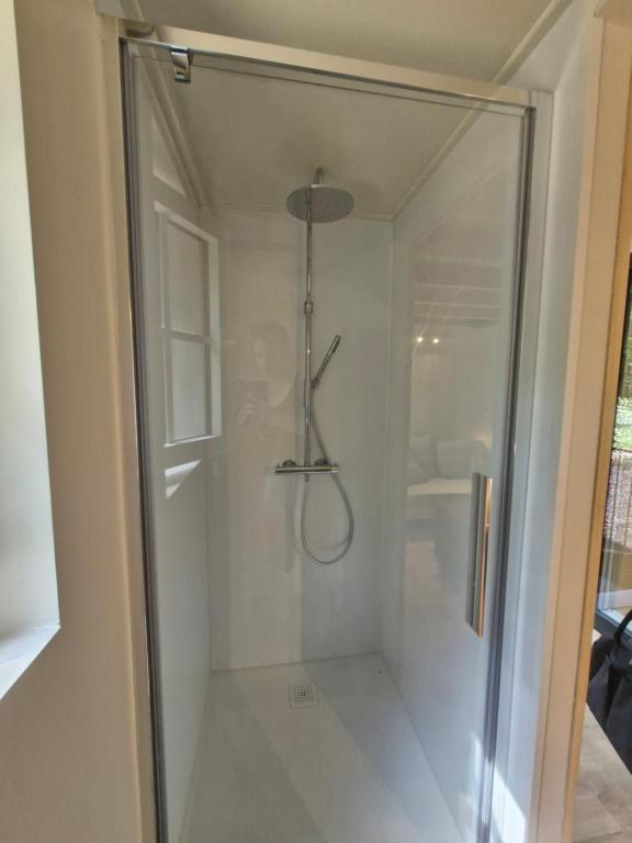 a shower with a glass door in a bathroom at oud in Zonnebeke