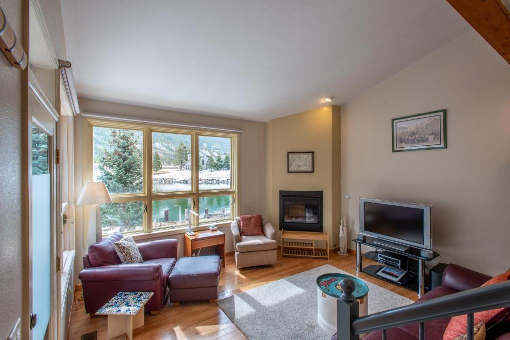 a living room with a couch and a television at The Woods 8 in Copper Mountain
