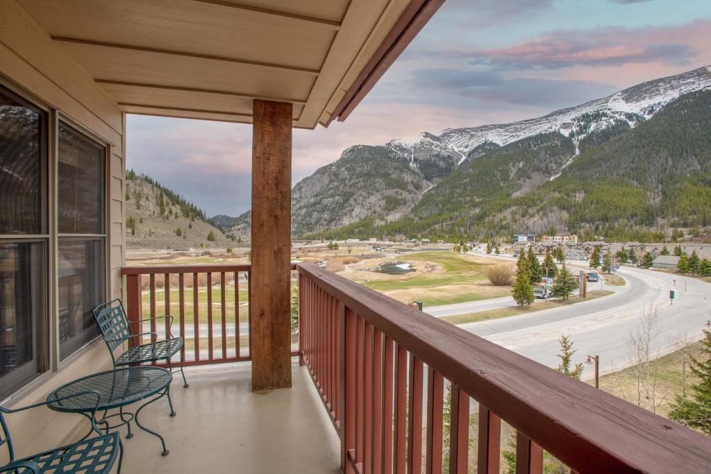 a balcony with a table and chairs and mountains at Copper Springs Lodge 426 in Copper Mountain
