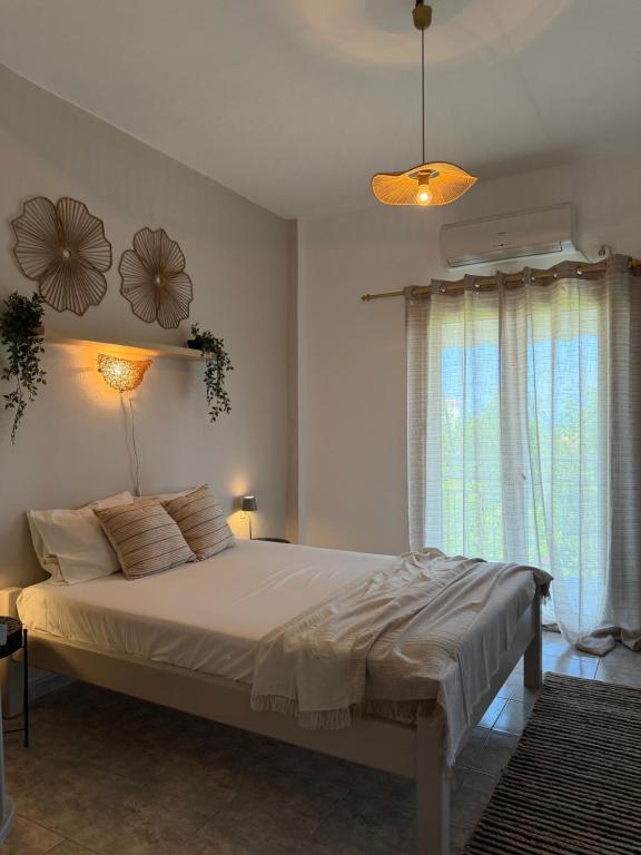 a bedroom with a large bed and a window at The Beach House in Vasilika