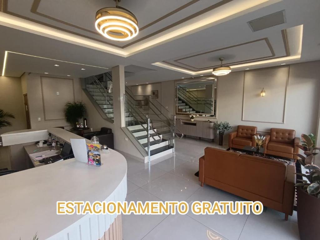a living room with a staircase and a lobby at Hotel Hiperion Maringá in Maringá