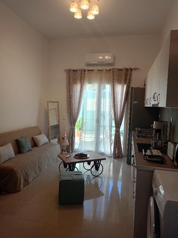 a living room with a couch and a table at The Eliana Serenade in Heraklio