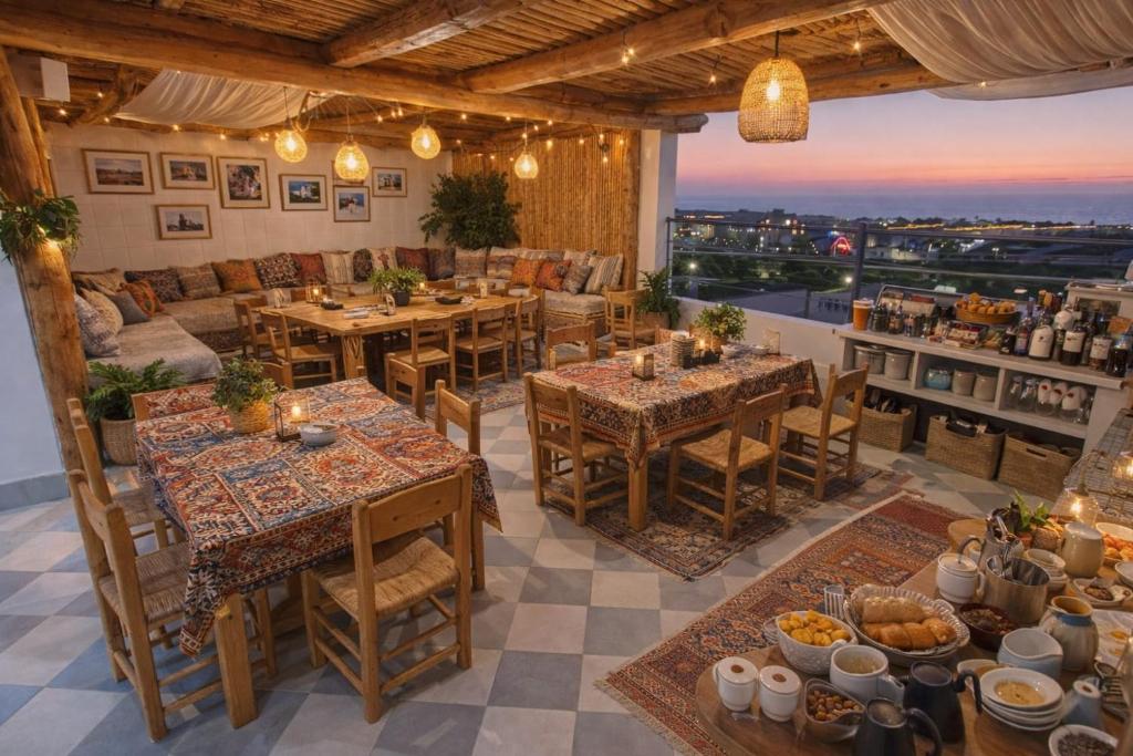 a restaurant with tables and a view of the city at Tamrazen retreat in Tamraght Ouzdar
