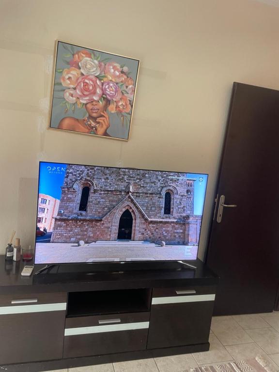 a flat screen tv sitting on top of a dresser at Serres Heart Suite in Serres