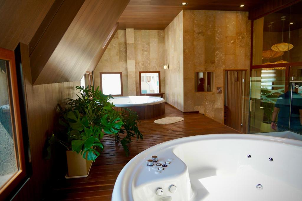 a large bathroom with a bath tub and a tub at Empire Hotel Buenos Aires in Buenos Aires