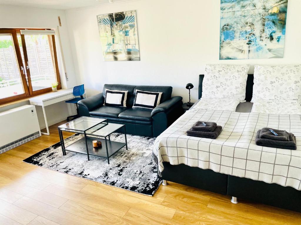 a living room with a bed and a couch at Relax Holidays in Rheinheim