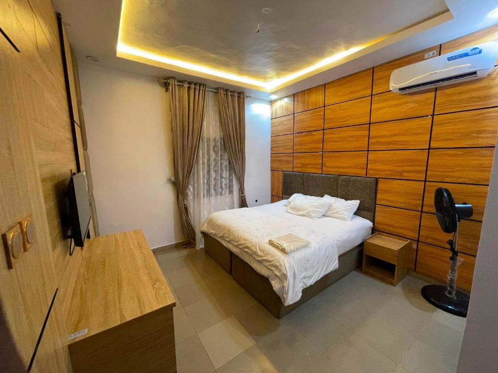 a hotel room with a bed and a television at MOTISOFT Hotel in Yenagoa